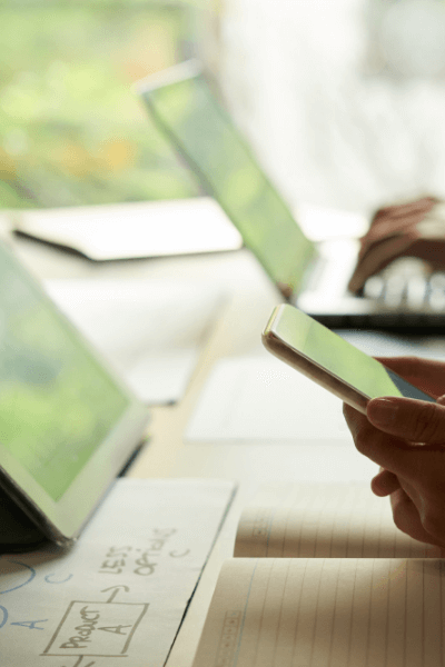 Hands business person checking messages smartphone with coworker